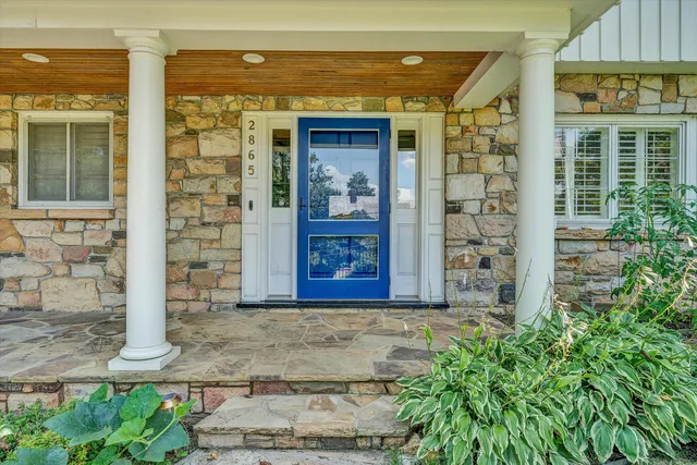 front view of a brick house with large windows
