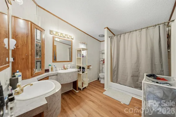 a large spacious bathroom with a double vanity sink a mirror and a bathtub