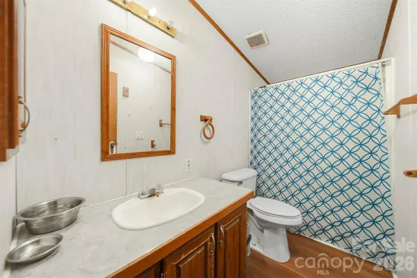 a bathroom with a sink mirror vanity and toilet
