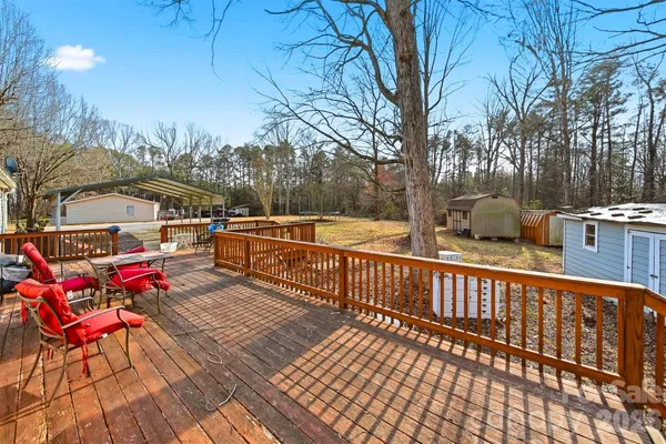 a view of balcony with wooden floor and outdoor seating