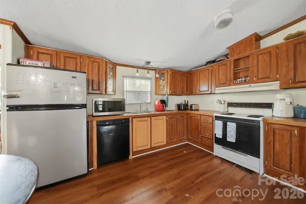 a kitchen with stainless steel appliances granite countertop a refrigerator sink and cabinets