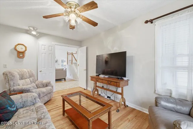 a living room with furniture and floor to ceiling windows