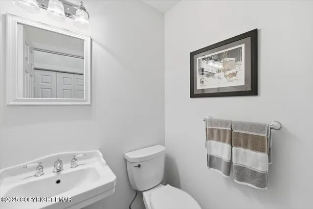 a living room with furniture pool table and a flat screen tv