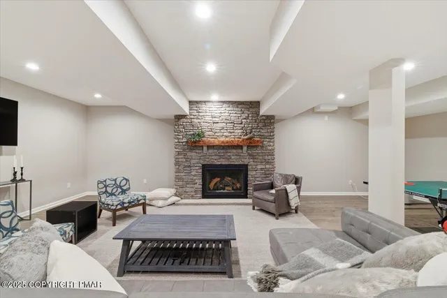 a living room with furniture and a fireplace