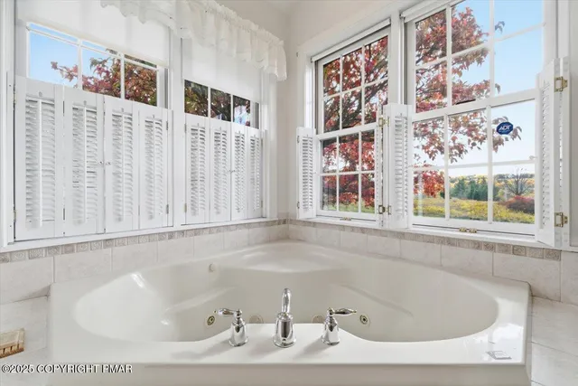 a living room with furniture a chandelier and kitchen view