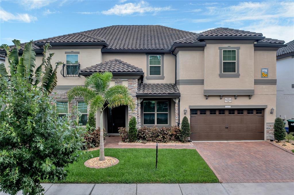 14133 Ward Road Orlando, FL 32824 - Photo 1 of 1 a front view of a house with a yard and garage