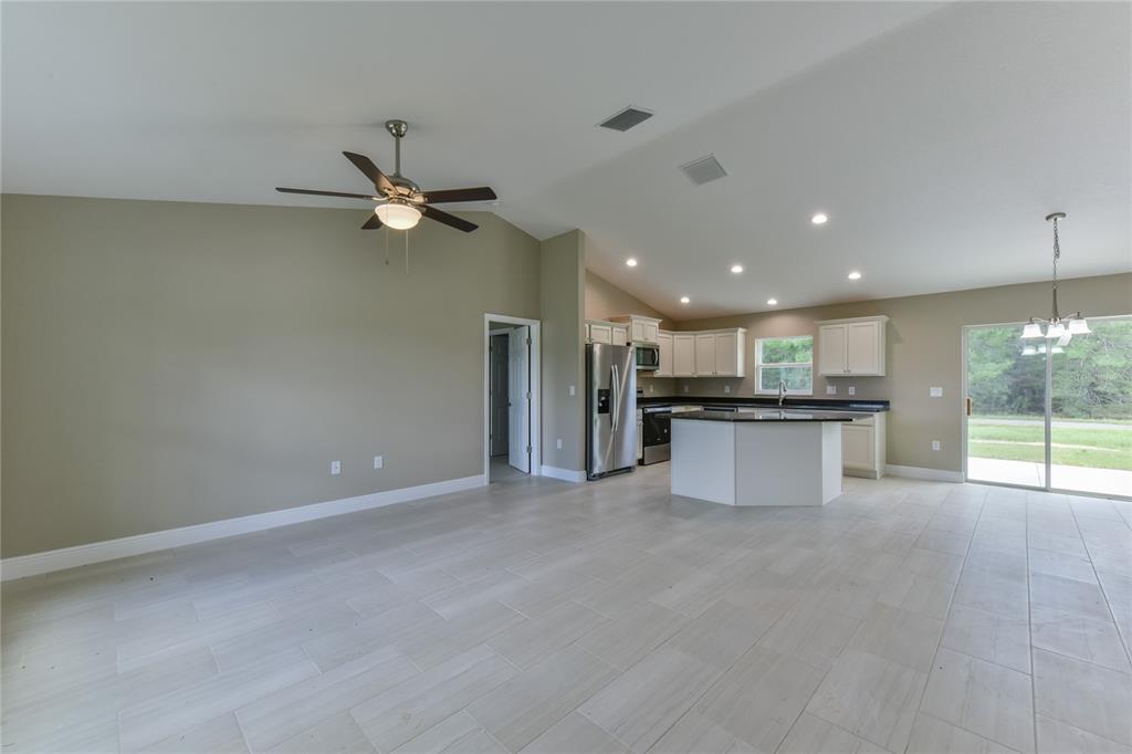 16219 Southwest 48th Circle Ocala, FL 34473 - Photo 11 of 36 a view of a kitchen with a sink and refrigerator