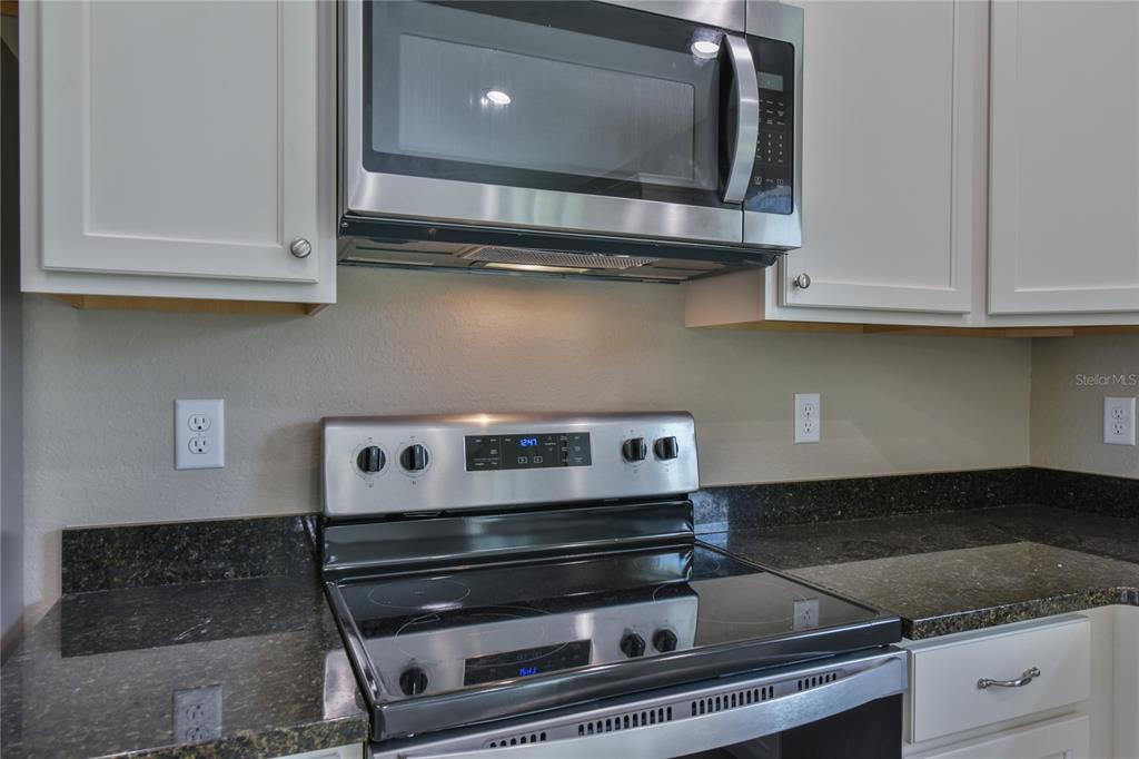 16219 Southwest 48th Circle Ocala, FL 34473 - Photo 18 of 36 a stove top oven sitting inside of a kitchen