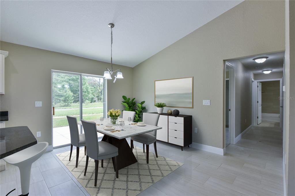 16219 Southwest 48th Circle Ocala, FL 34473 - Photo 19 of 36 a dining room with furniture a chandelier and a rug