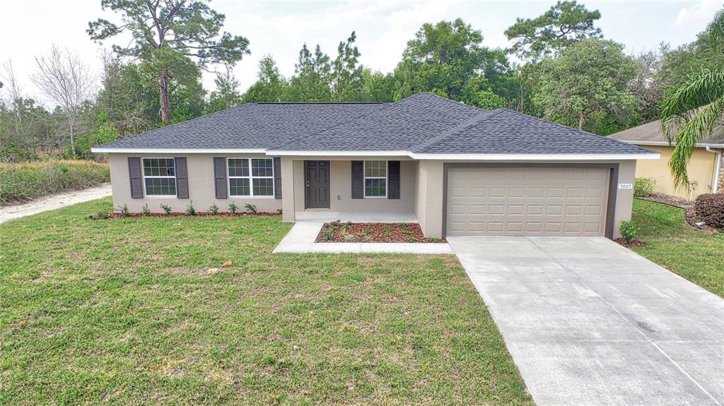 16219 Southwest 48th Circle Ocala, FL 34473 - Photo 2 of 36 a front view of a house with yard