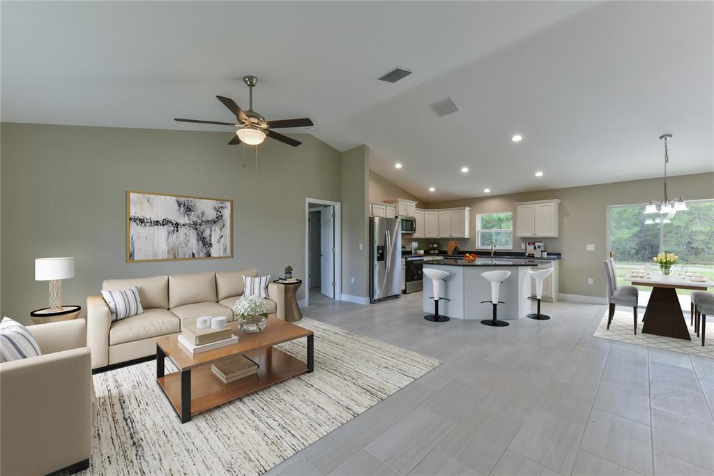 16219 Southwest 48th Circle Ocala, FL 34473 - Photo 10 of 36 a living room with furniture and kitchen view