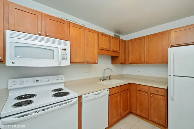 a kitchen with a sink a stove and cabinets