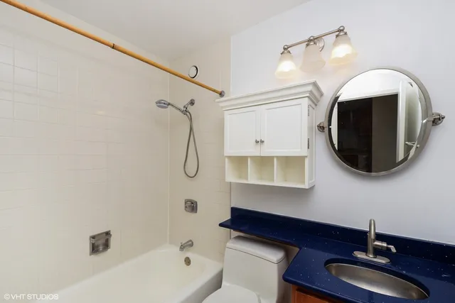 a bathroom with a tub sink and mirror