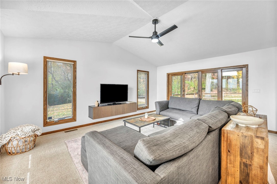 16340 Galehouse Road Doylestown, OH 44230 - Photo 28 of 50 Living room featuring vaulted ceiling, carpet flooring, and ceiling fan