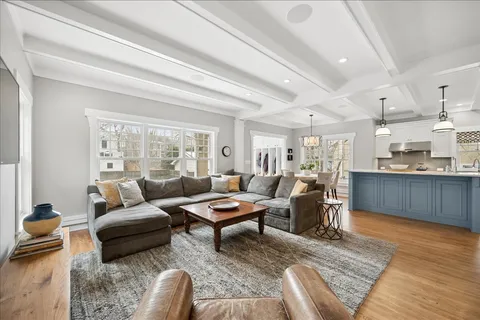 a kitchen with stainless steel appliances kitchen island granite countertop a table chairs and a refrigerator