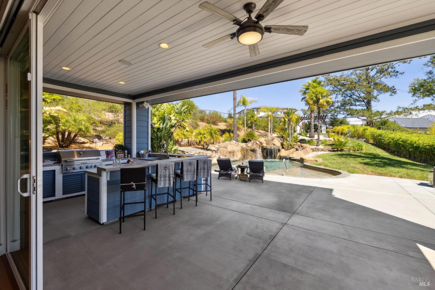 3882 Royal Manor Place Santa Rosa, CA 95404 - Photo 5 of 98 Located seamlessly off the great room, this out-door kitchen is set with a KitchenAid BBQ that has natural gas run to it so you wont need to fill propane tanks, bar seating for 8, outdoor refrigerator, outdoor sink, and plenty of open and shaded seating area.