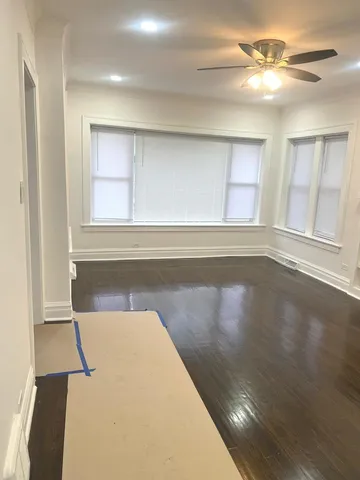a view of a room with wooden floor and a window