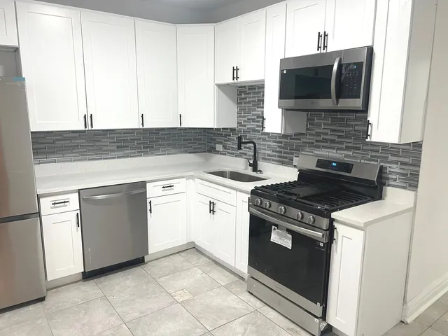 a kitchen with a stove and a microwave