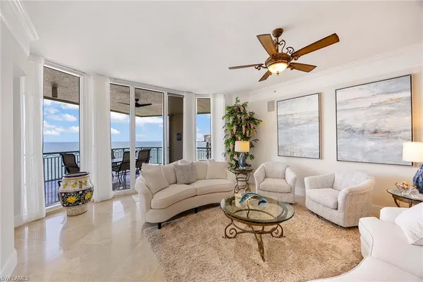a living room with furniture and kitchen view