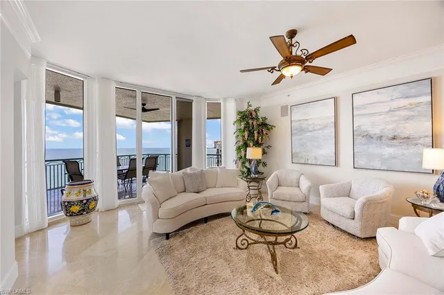 a living room with furniture and kitchen view