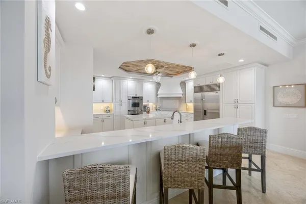a kitchen with sink and white cabinets