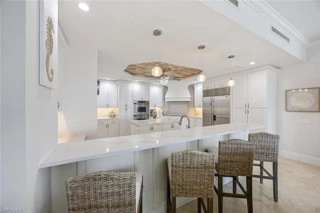 a kitchen with sink and white cabinets