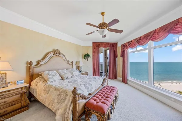 a living room with furniture and kitchen area