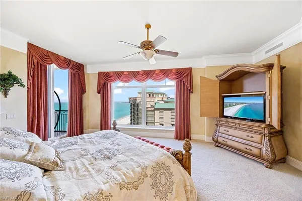 a bedroom with two beds and chandelier
