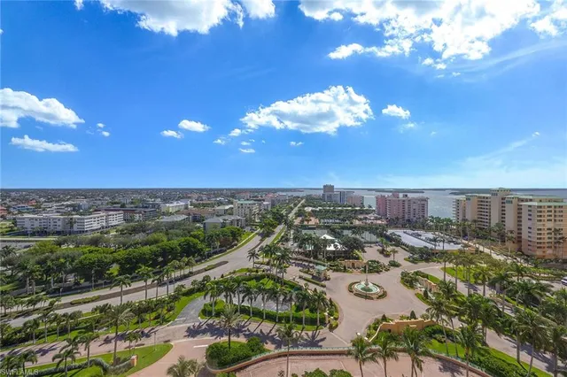 a living room with furniture a flat screen tv and a chandelier