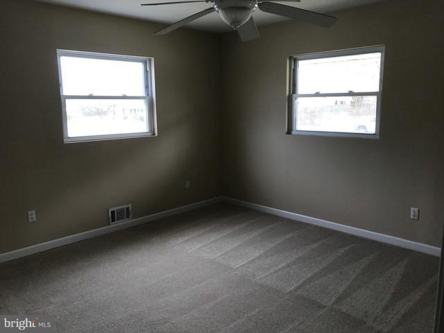 8149 Elizabeth Road Pasadena, MD 21122 - Photo 12 of 18 an empty room with a window