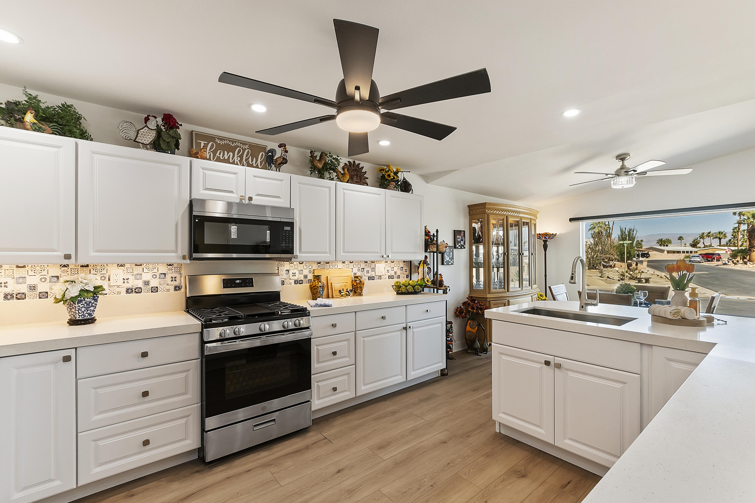 a kitchen with white cabinets sink and white appliances