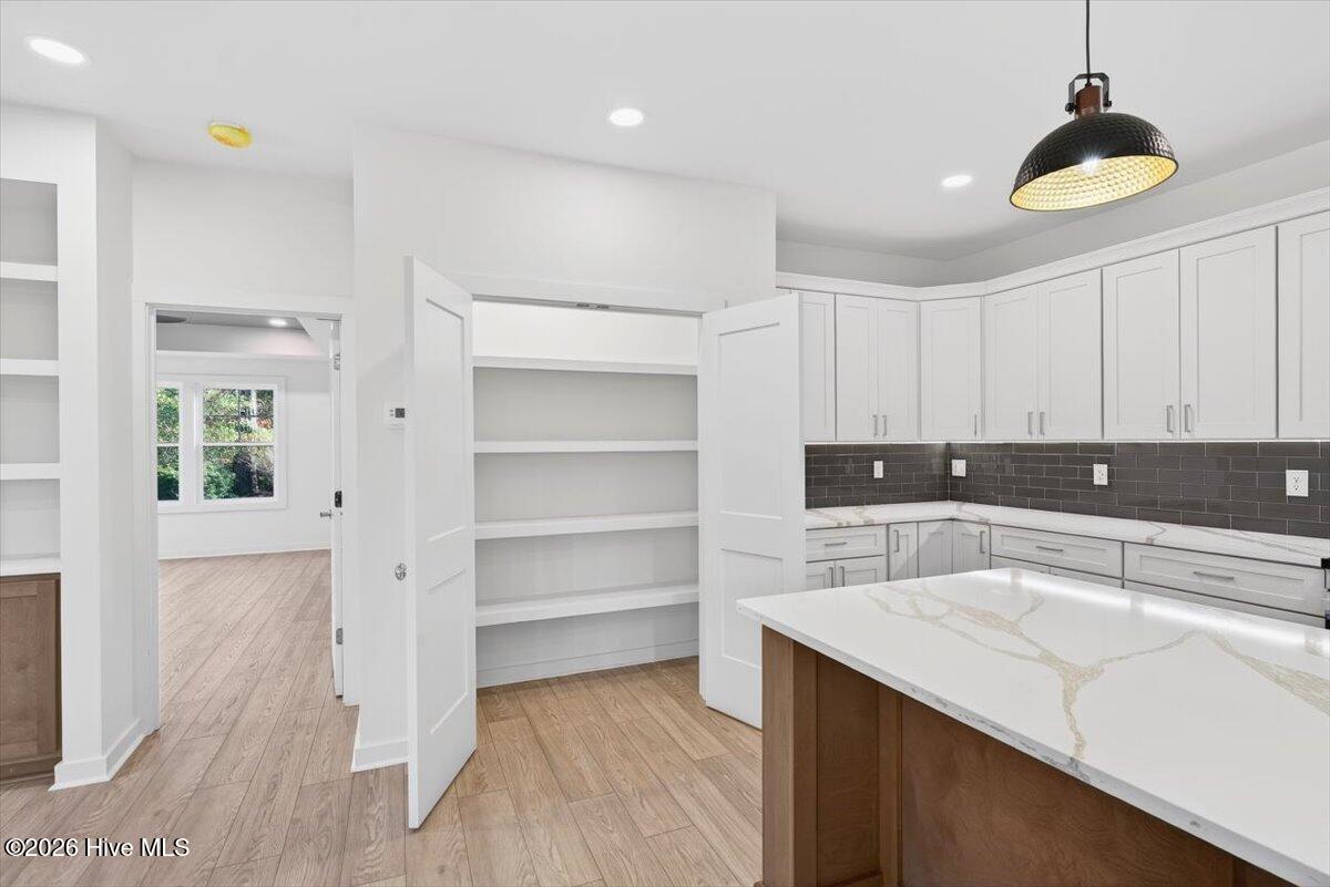 355 South Middleton Drive Northwest Calabash, NC 28467 - Photo 7 of 81 Coastal luxury kitchen with beautiful cabinetry, ample workspace, and an effortless connection to dining and living areas.