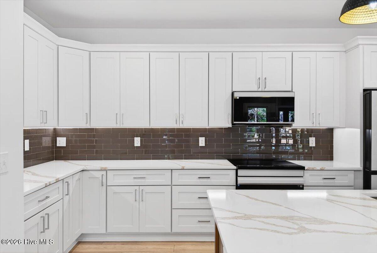 355 South Middleton Drive Northwest Calabash, NC 28467 - Photo 8 of 81 Island kitchen perfection—stylish, spacious, and open to the main living area for effortless entertaining.