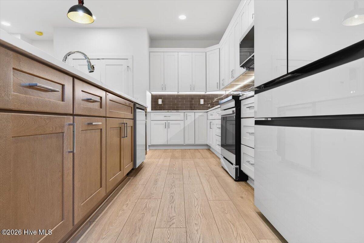 355 South Middleton Drive Northwest Calabash, NC 28467 - Photo 9 of 81 Stylish kitchen includes modern appliances and upgraded finishes—new construction convenience at its best.