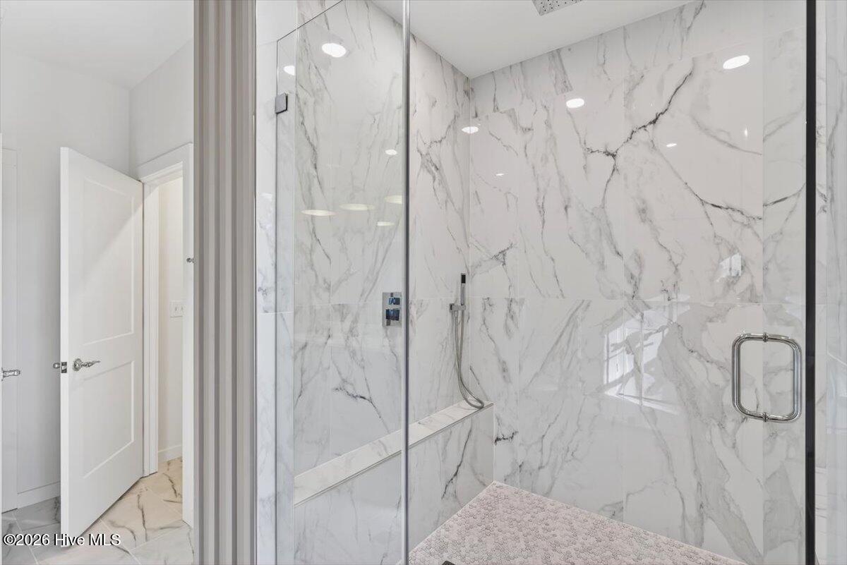 355 South Middleton Drive Northwest Calabash, NC 28467 - Photo 14 of 81 Main-level primary suite featuring a spa-inspired bathroom and walk-in shower for everyday comfort and relaxation.