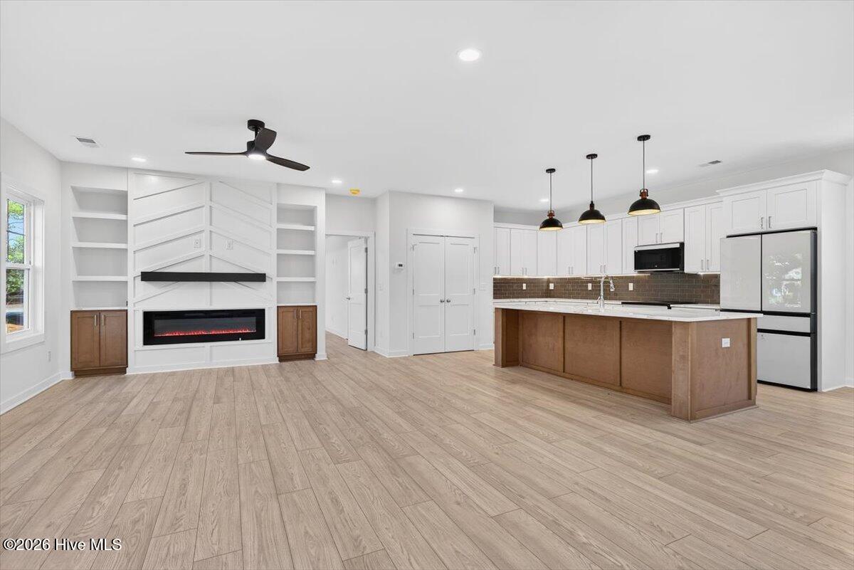 355 South Middleton Drive Northwest Calabash, NC 28467 - Photo 3 of 81 Bright open-concept layout with designer fixtures and luxury LVP flooring throughout the main living areas—perfect for entertaining.