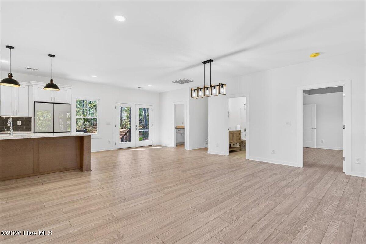 355 South Middleton Drive Northwest Calabash, NC 28467 - Photo 4 of 81 Spacious living room with high ceilings and seamless flow into the kitchen and dining—ideal for coastal North Carolina living.