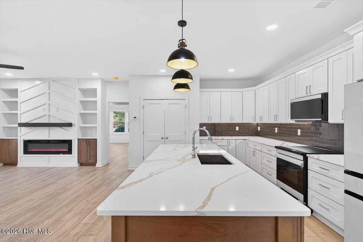 355 South Middleton Drive Northwest Calabash, NC 28467 - Photo 5 of 81 Gourmet kitchen with large island, custom cabinetry, and premium finishes—an ideal centerpiece for hosting and family gatherings.