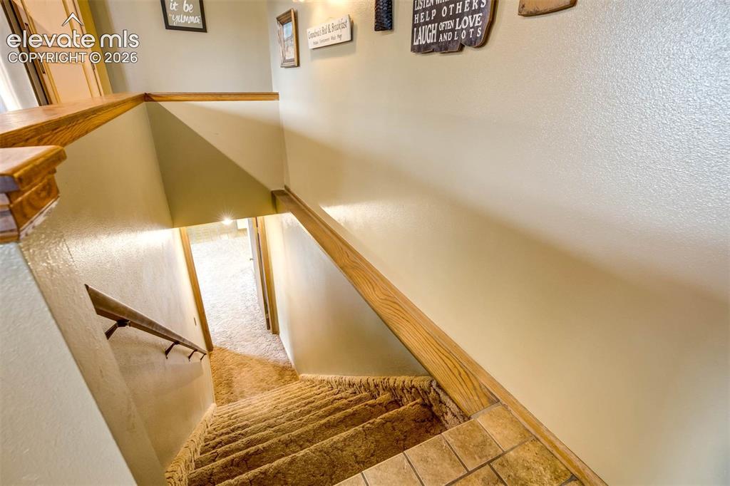 7585 Ponca Road Colorado Springs, CO 80908 - Photo 25 of 49 bsmnt stairs frm kitchen