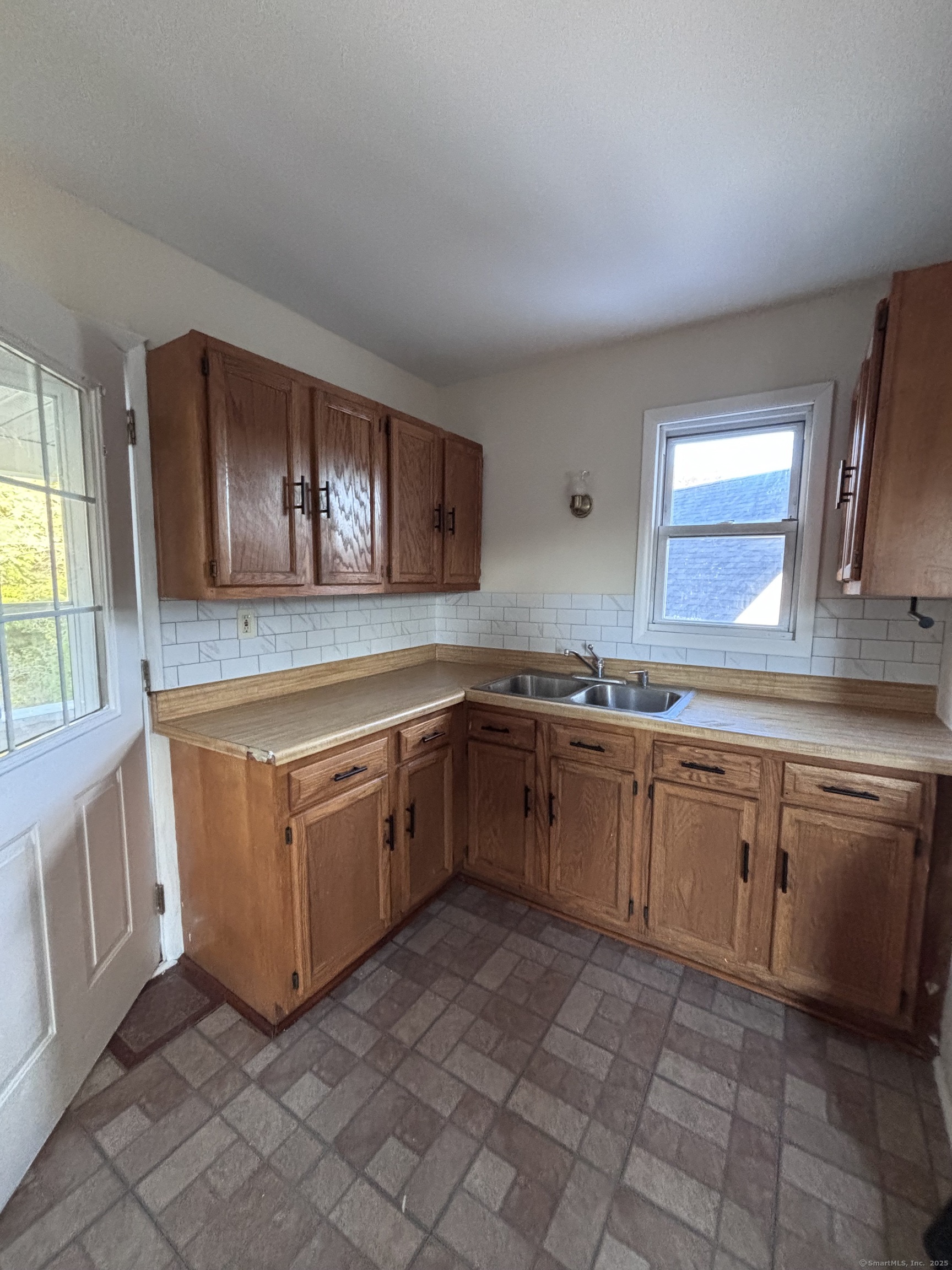 a kitchen with stainless steel appliances granite countertop a sink and cabinets