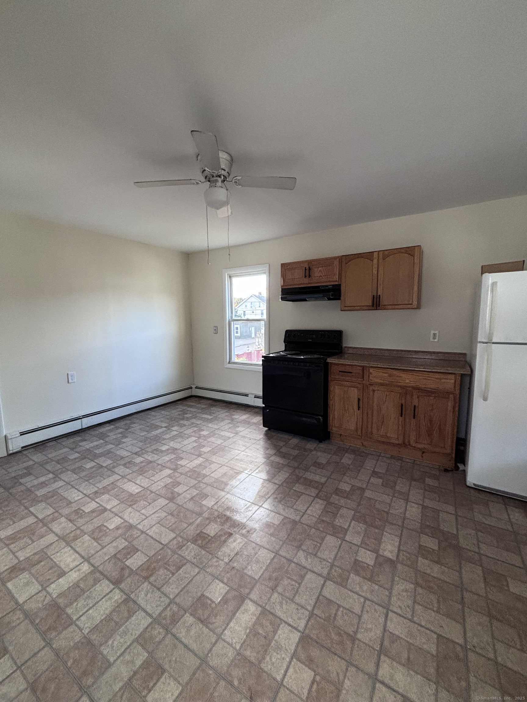 33 Aetna Street, Unit 2 Naugatuck, CT 06770 - Photo 2 of 4 a large kitchen with cabinets and a stove top oven