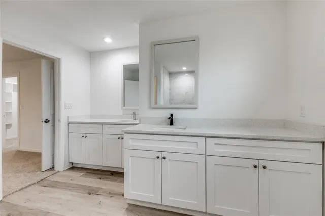 a spacious bathroom with a granite countertop sink mirror and