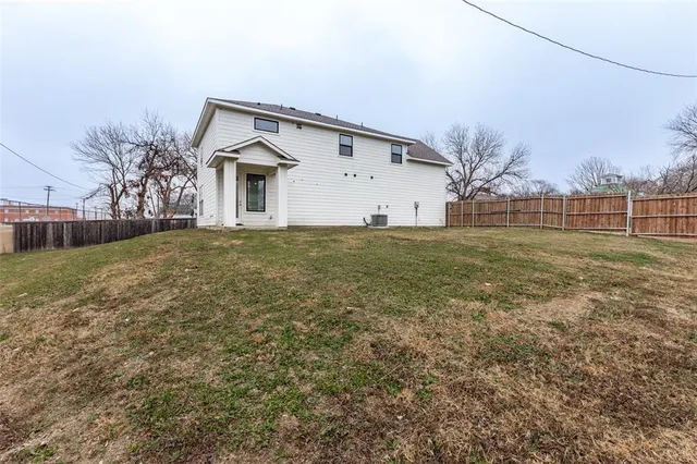 a view of a house with a yard and garage
