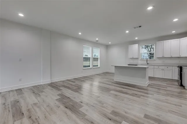 a view of kitchen with kitchen island and stainless steel appliances