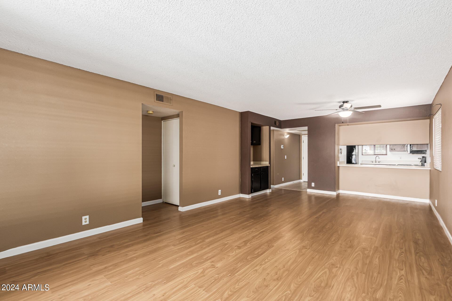 4150 East Cactus Road, Unit 118 Phoenix, AZ 85032 - Photo 8 of 19 Large Great Room Towards Kitchen