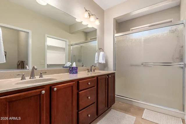 a bathroom with a double vanity sink and a mirror