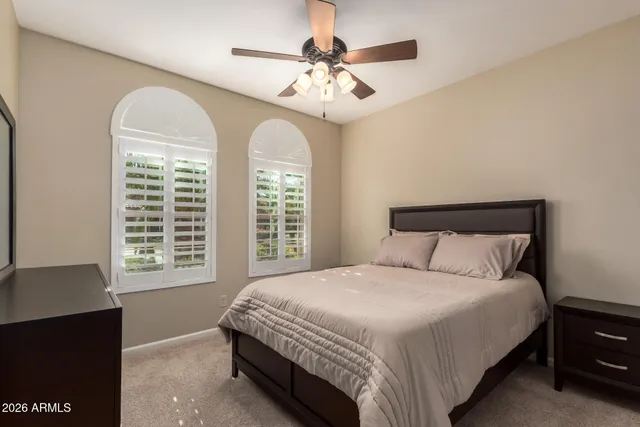 a bedroom with a large bed and a chandelier