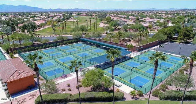 an aerial view of a house with a garden and lake view