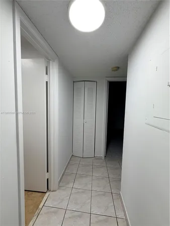 a view of a closet area with ceiling fan