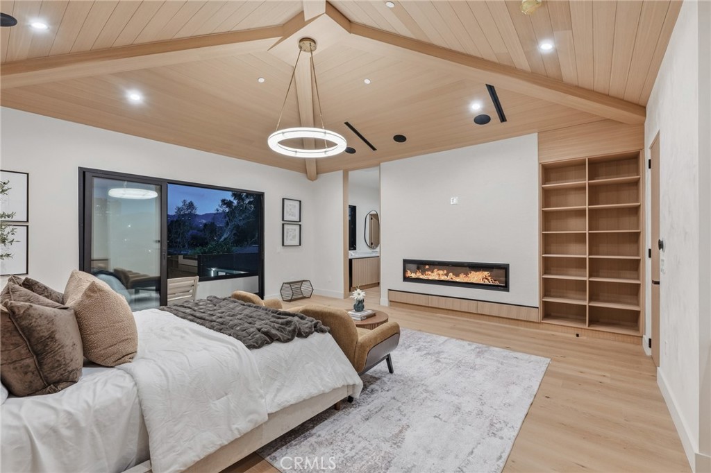 16252 Addison Street Encino, CA 91436 - Photo 12 of 36 a spacious bedroom with a large bed and a large window